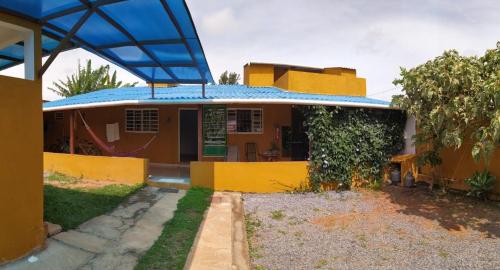 
a blue and yellow bus parked in front of a building at Suites Cerrado in Alto Paraíso de Goiás
