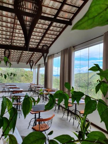 
a dining room table with chairs and umbrellas at Pousada Casa de Shiva in Alto Paraíso de Goiás
