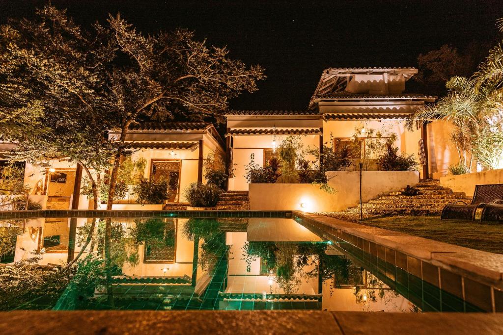 
a large building with a pool of water in front of it at Pousada Casa de Shiva in Alto Paraíso de Goiás
