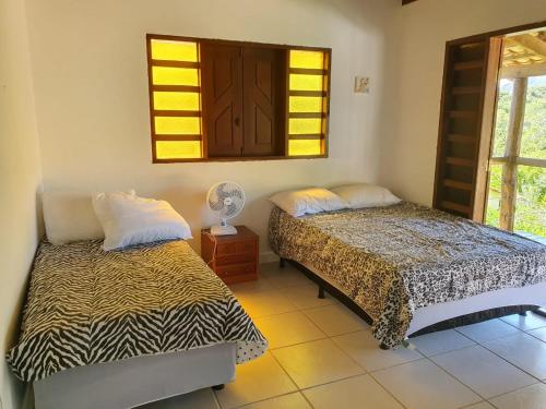
A bed or beds in a room at Casa da Rua 1 - Cavalcante/GO
